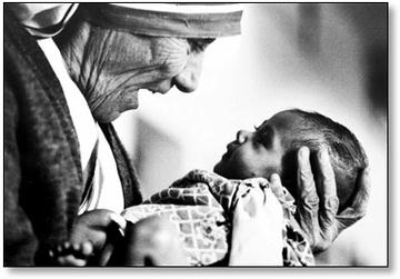 Mother Teresa of Calculla joyfully looks into the eyes of a child